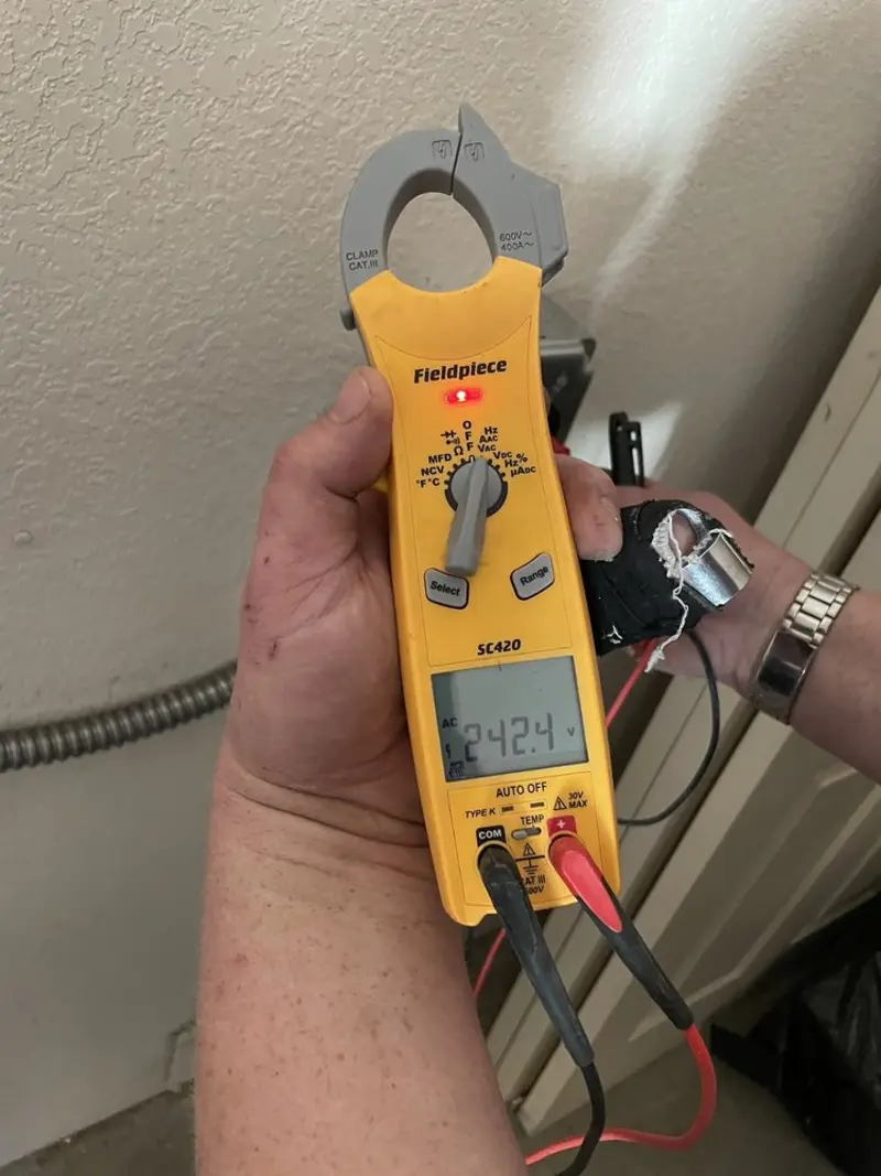 Voltage testing with clamp meter during Recessed Lighting Installation in Anna